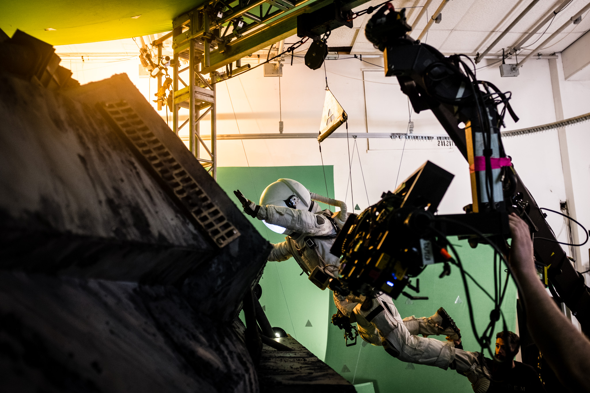 A spacesuit scene being filmed on a green-screen stage